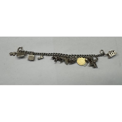 1174 - A quantity of silver items to include chains & charm bracelet with some silver charms