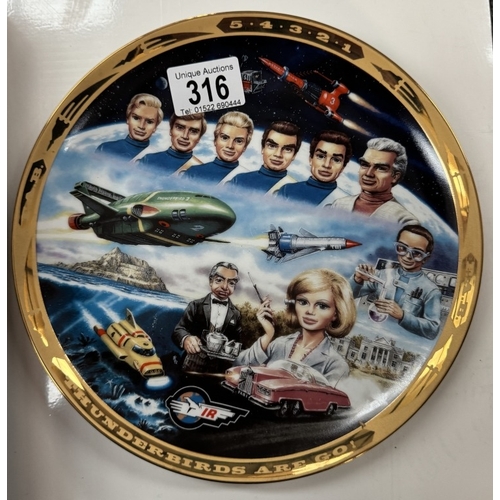 316 - A Thunderbirds plate, 2 paperbacks & a Matchbox BBC Radio Times die cast commemorative set etc.