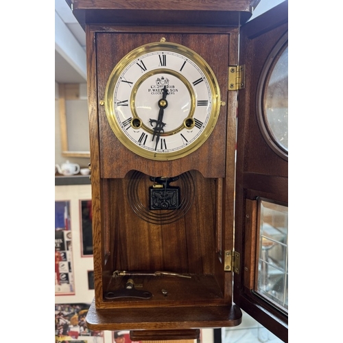 1403 - A small oak wall clock by P Watts & Sons, clockmakers. COLLECT ONLY