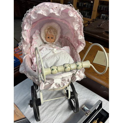 195A - A vintage wicker dolls pram with pink covering