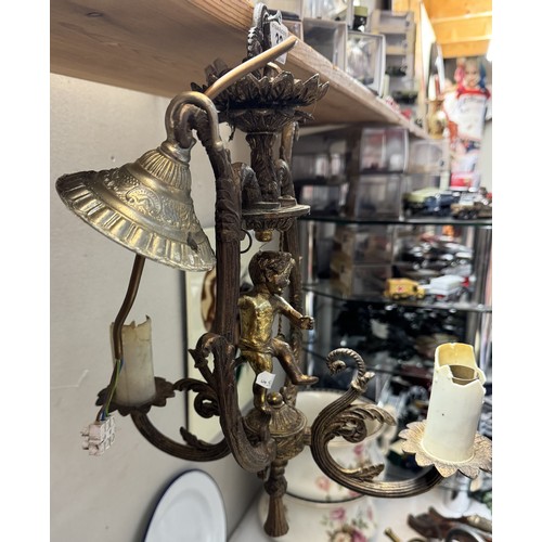 32 - A cherub surmounted gilded metal ceiling light