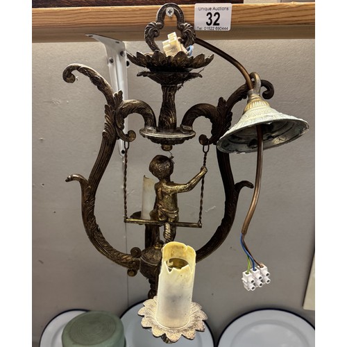 32 - A cherub surmounted gilded metal ceiling light