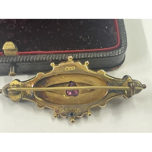 1017 - A Victorian 9ct gold brooch set amethyst and seed pearls, 5 cm wide, 3.98 grams.