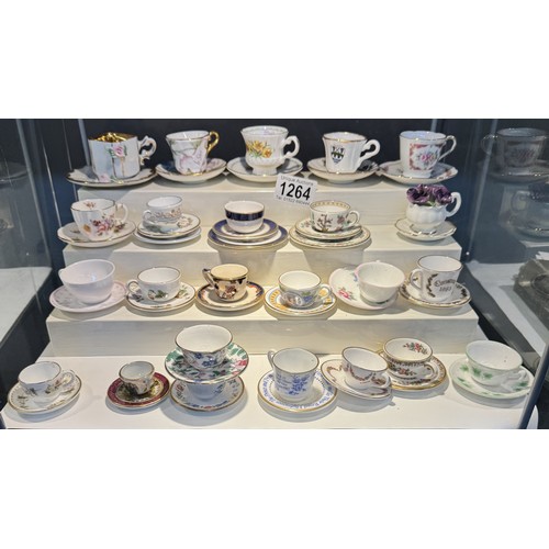 1264 - In excess of twenty miniature cups & saucers including Royal Crown Derby, Royal Doulton, Wedgwood et... 