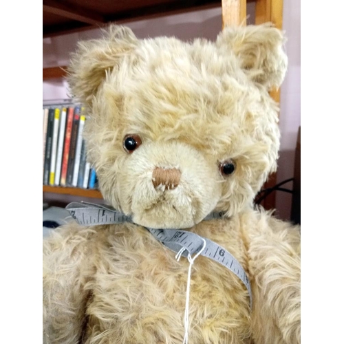 1658 - A vintage straw filled growler teddy in tired condition. No labels