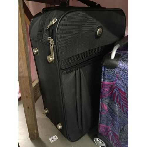 1664 - A new back pack with labels, 2 suitcases & a ladies bag COLLECT ONLY