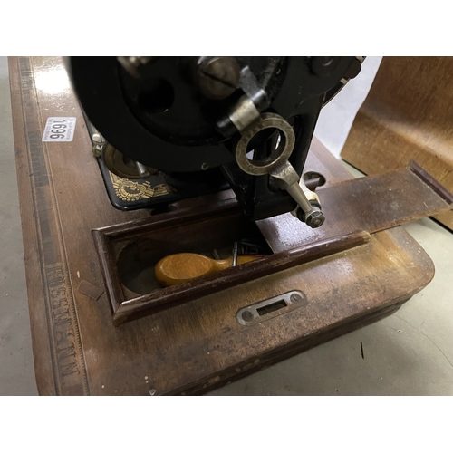 1696 - A vintage cased Frister and Rossman sewing machine, COLLECT ONLY.