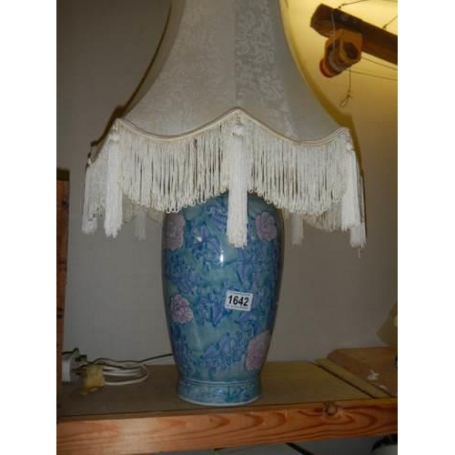 1642 - A good blue ceramic table lamp with fringed shade, COLLECT ONLY.