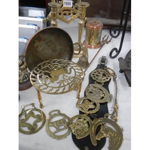 1680 - A mixed lot of brassware including candlesticks, trivet, horse brasses etc.,