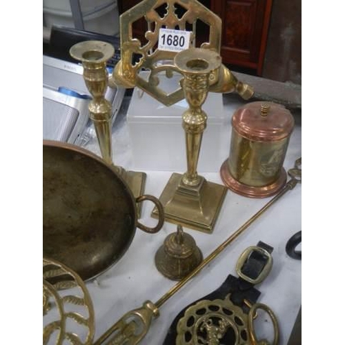 1680 - A mixed lot of brassware including candlesticks, trivet, horse brasses etc.,