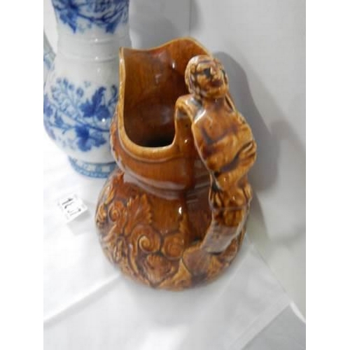 1887 - A 19th century blue and white jug together with a brown pottery jug.