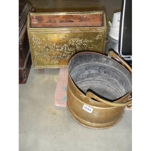 1694 - A brass magazine rack and a brass coal scuttle.