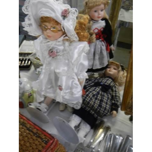 1756 - Four porcelain headed collector's dolls on stands.