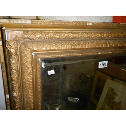 1768 - A bevel edged mirror in original Victorian gilt frame, a/f, COLLECT ONLY.