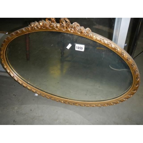 1859 - A mid 20th century oval gilt framed mirror, COLLECT ONLY.