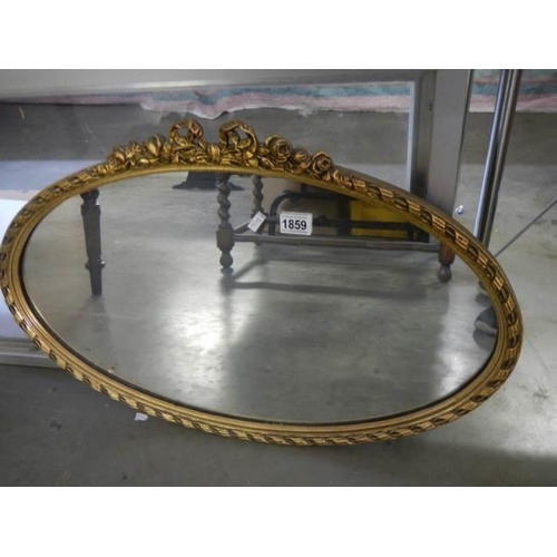 1859 - A mid 20th century oval gilt framed mirror, COLLECT ONLY.