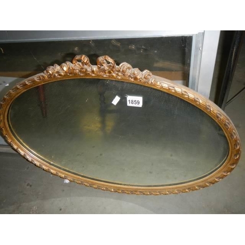 1859 - A mid 20th century oval gilt framed mirror, COLLECT ONLY.