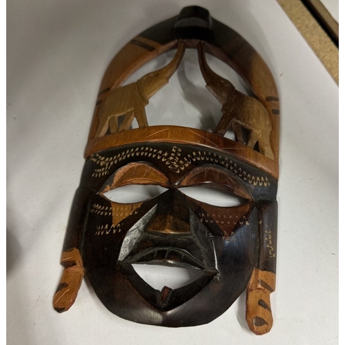 1647 - A quantity of wooden masks etc.