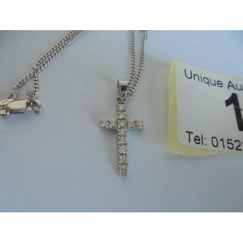 1 - An 18ct white gold and diamond cross on an 18ct gold chain. 4.37 grams