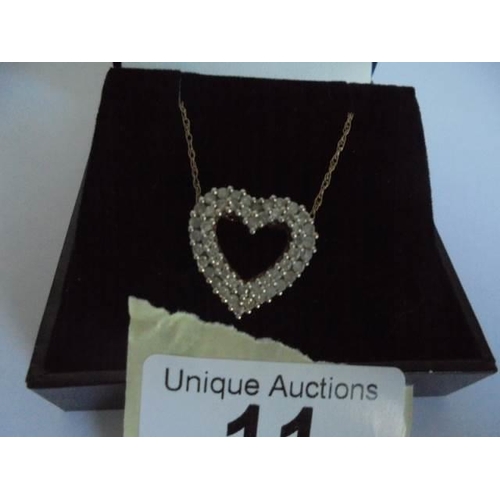 11 - A white gold and diamond heart on a 9ct gold chain, 4 grams.