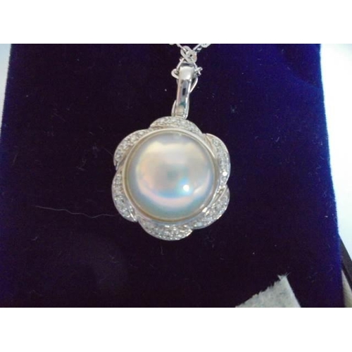 12 - A 14ct gold diamond and pearl pendant on a 14ct gold chain, 7.69 grams.