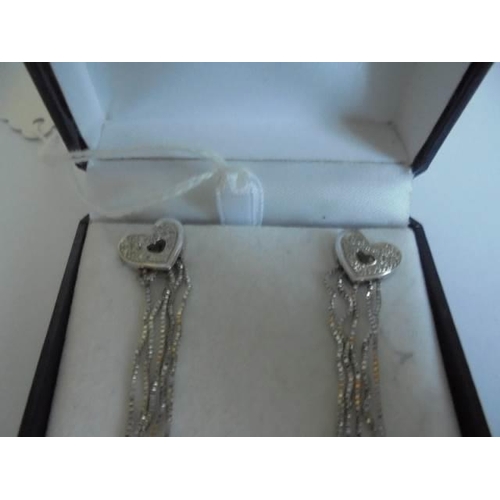 14 - A pair of 18ct white gold dangley earrings. 5.59 grams.