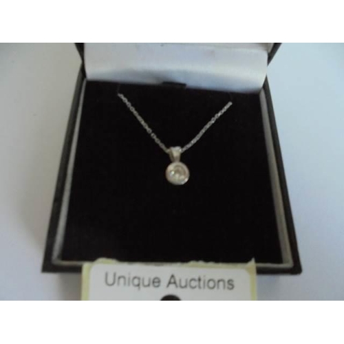 8 - A 9ct gold chain with quarter carat solitaire diamond pendant, 1.95 grams.