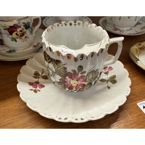 1721 - A large early 20th century moustache cup & saucer & 4 cups & saucers