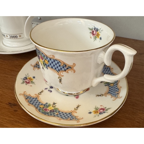 1721 - A large early 20th century moustache cup & saucer & 4 cups & saucers