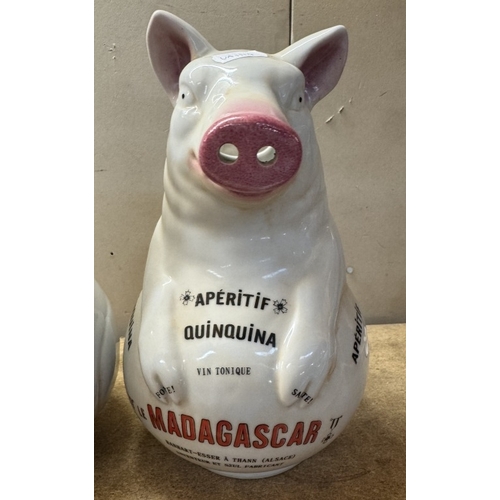 1730 - A pair of ceramic pig advertising water jugs