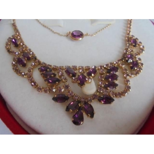 22 - A good quality necklace and pendant set amethyst coloured stones.