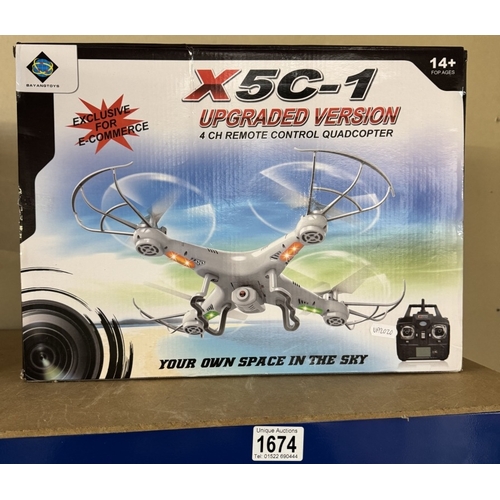 1674 - A boxed Bayangtoys X5C-1 remote control quadcopter