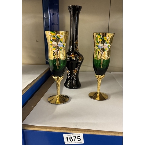 1675 - A pair of gilt & hand painted on green glass flute glasses & a vase of similar style