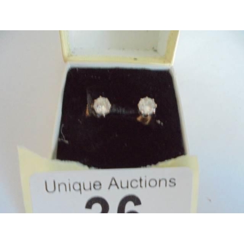 36 - A pair of 9ct gold and diamond stud earrings.