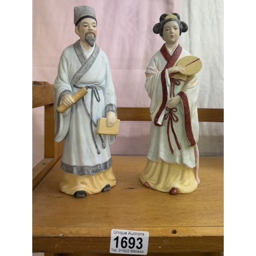 1693 - 2 oriental style unglazed ceramic figures, height 26cm