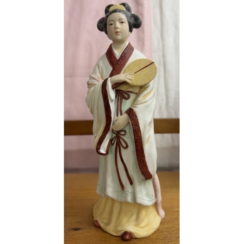 1693 - 2 oriental style unglazed ceramic figures, height 26cm