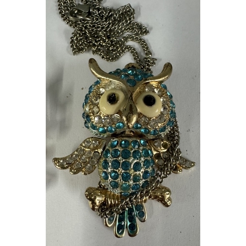 1790 - A large gemstone articulated owl pendant on chain & an owl group brooch