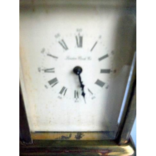 113 - A miniature brass carriage clock marked 'London Clock Co.,' in working order.