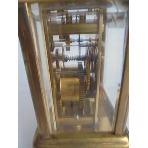 113 - A miniature brass carriage clock marked 'London Clock Co.,' in working order.