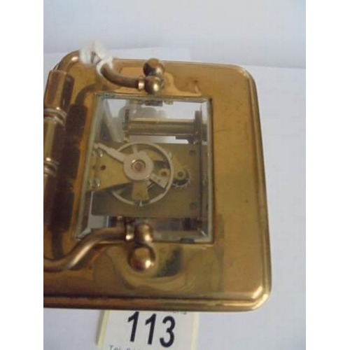 113 - A miniature brass carriage clock marked 'London Clock Co.,' in working order.