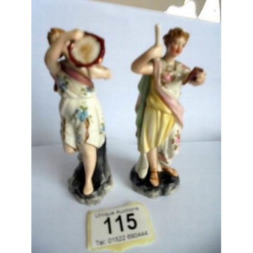 115 - A pair of 19th century continental porcelain musician figurines.