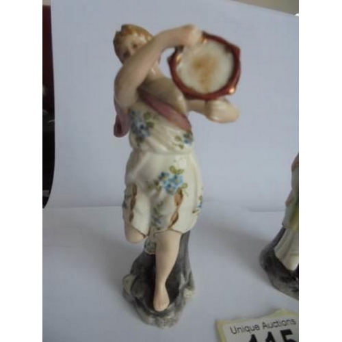 115 - A pair of 19th century continental porcelain musician figurines.