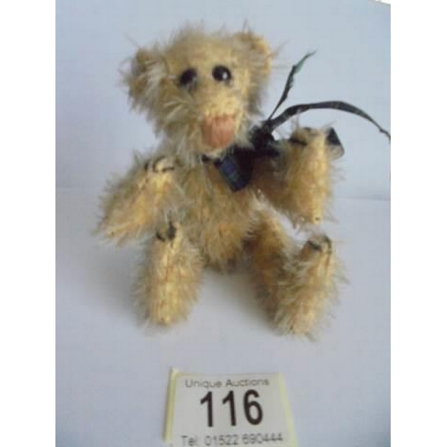 116 - A miniature jointed Teddy bear.