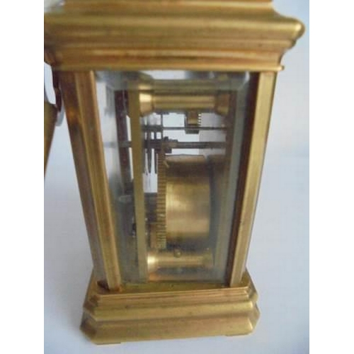 120 - A miniature brass carriage clock,   in working order.