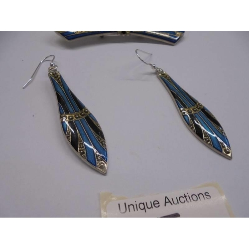 15 - A pair of art deco style earings with silver hooks and a matching brooch.