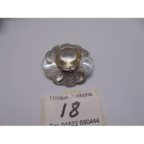 18 - A Scottish chased silver brooch with centre quartz.