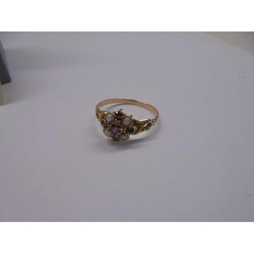 19 - A 19th century ring set Amethyst, pearls and garnet in a cluster with openwork shoulders, tests as 1... 