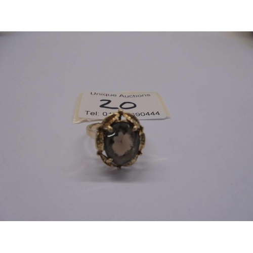 20 - A circa 1970's 9ct gold ring set with a smoky quartz in a textured mount, size N, 4.12 grams.