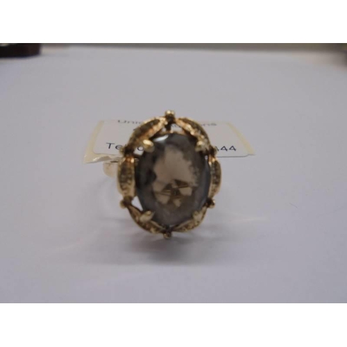 20 - A circa 1970's 9ct gold ring set with a smoky quartz in a textured mount, size N, 4.12 grams.