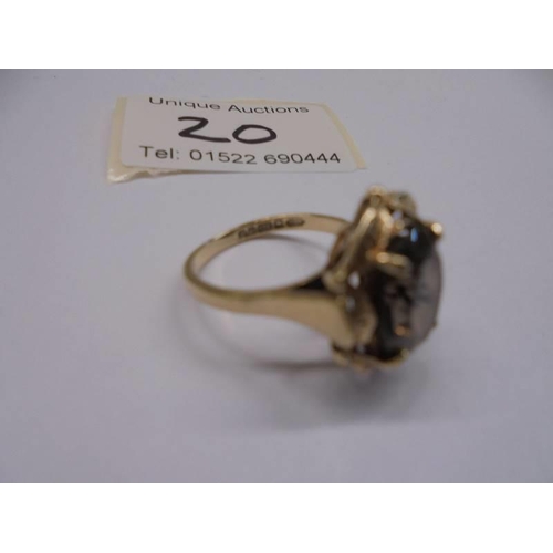 20 - A circa 1970's 9ct gold ring set with a smoky quartz in a textured mount, size N, 4.12 grams.